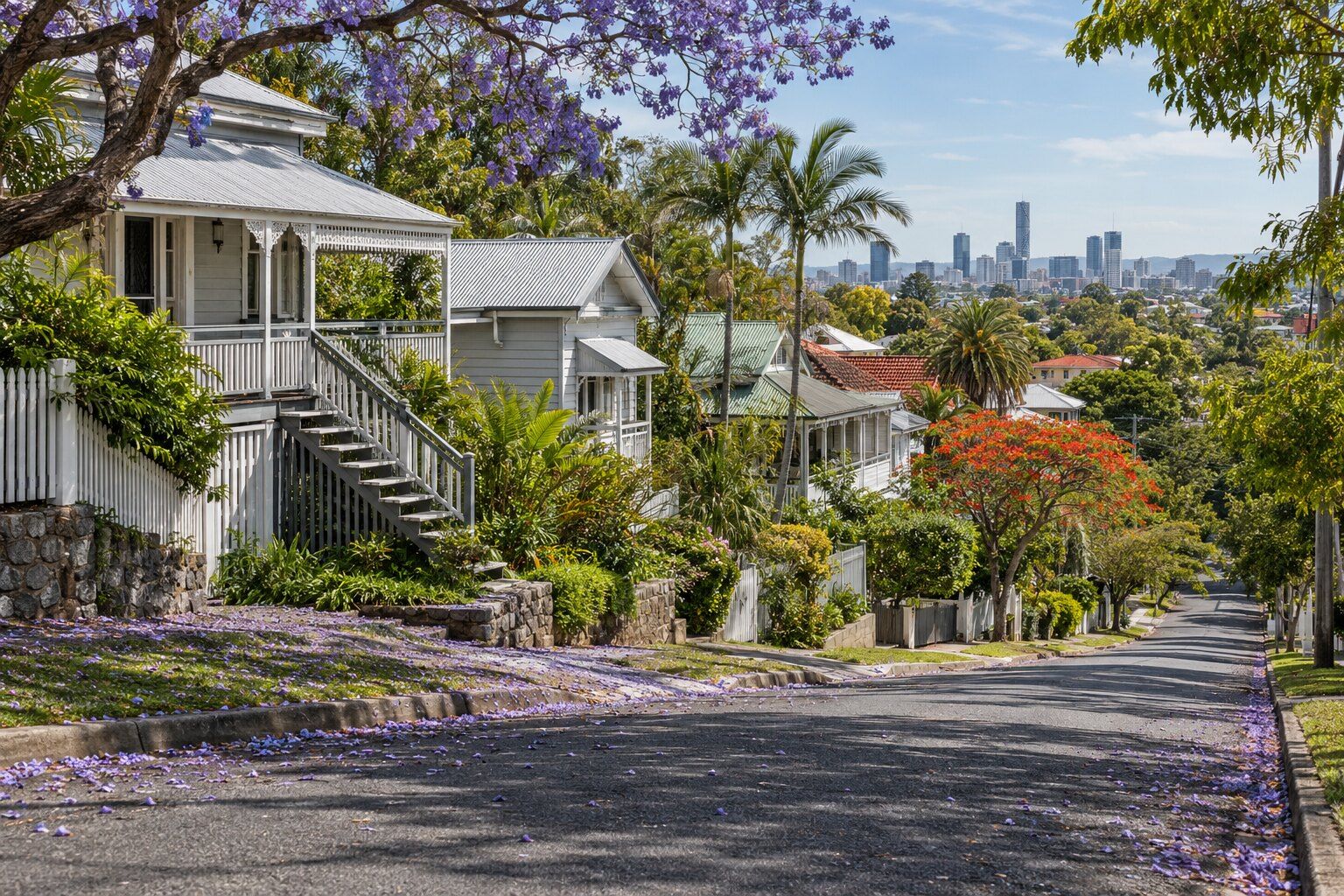 Roofing, Wilston: timber Queenslanders on tall stumps with corrugated iron roofs stepping up a steep, leafy street