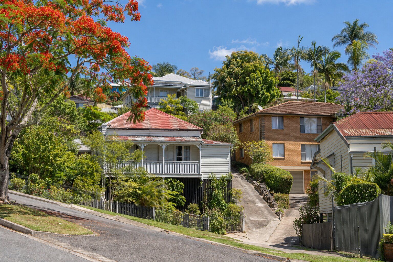 Roofing, Windsor: timber workers' cottages on high stumps with red corrugated iron roofs on a hillside street